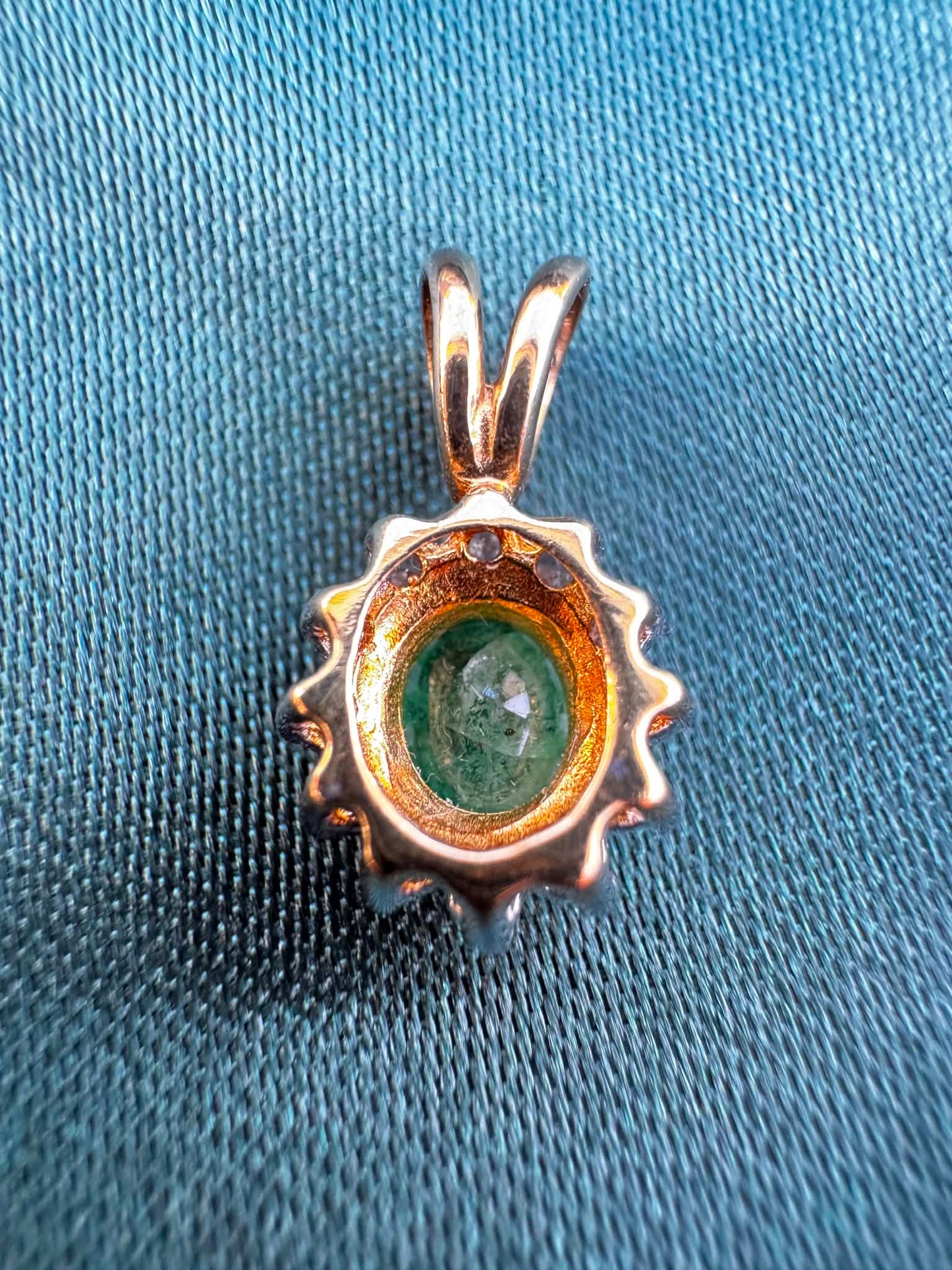 Emerald and diamond halo pendant in two-tone 9ct gold, reverse side showing bail and pendant back
