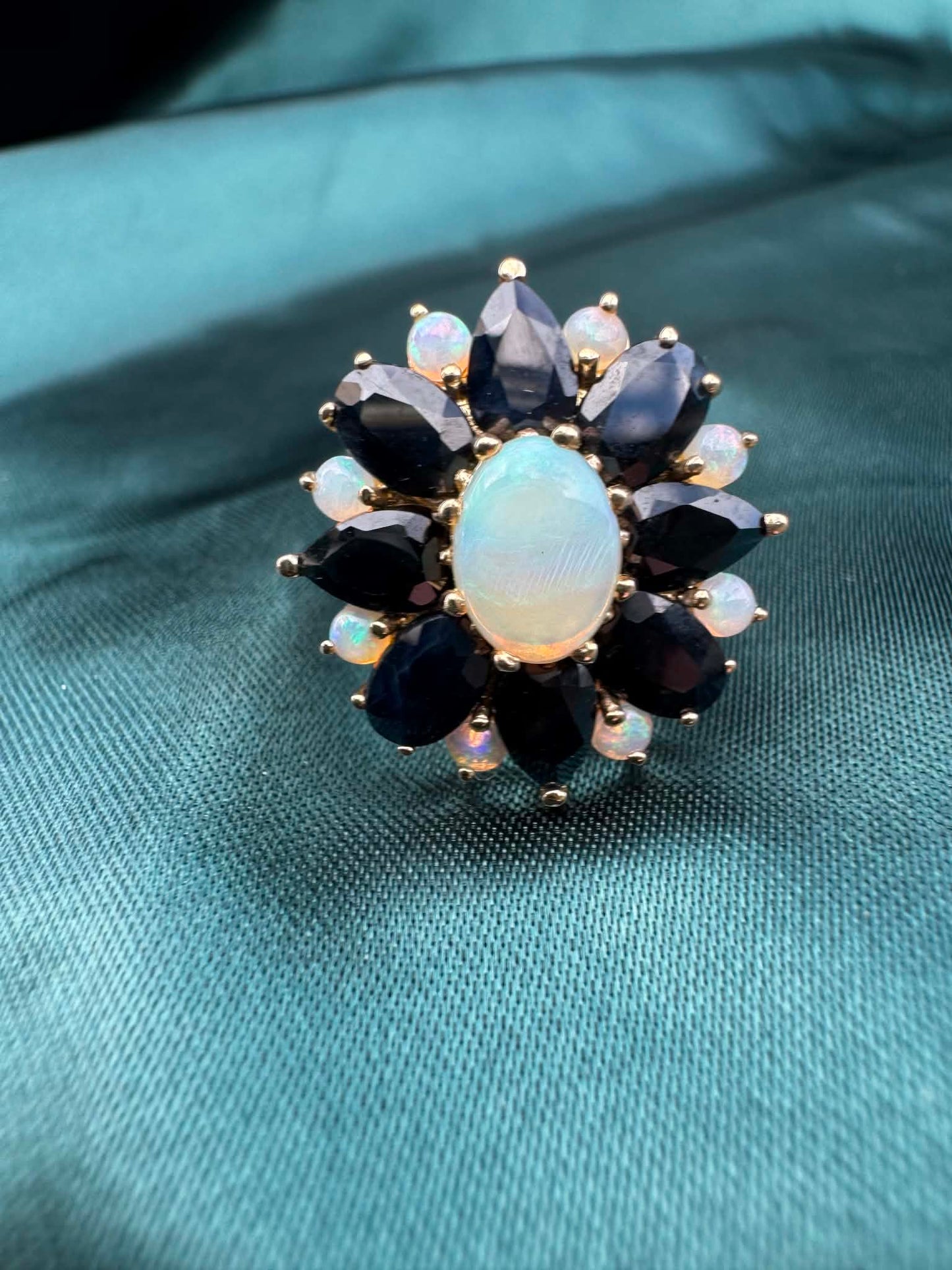 Opal and sapphire cluster ring in 9ct gold, close-up of opal and sapphire cluster setting