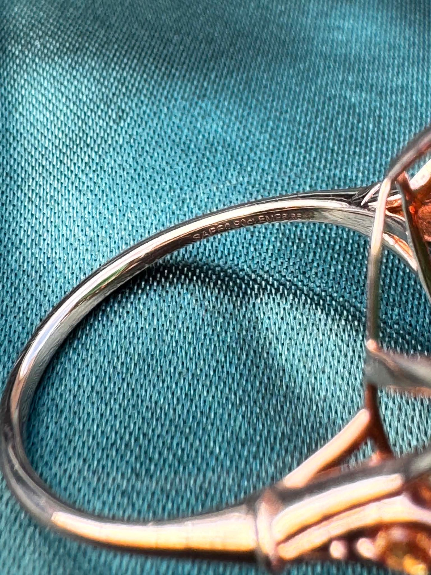 Emerald and orange sapphire cocktail ring in 14ct rose gold, side profile showing band and bezel setting