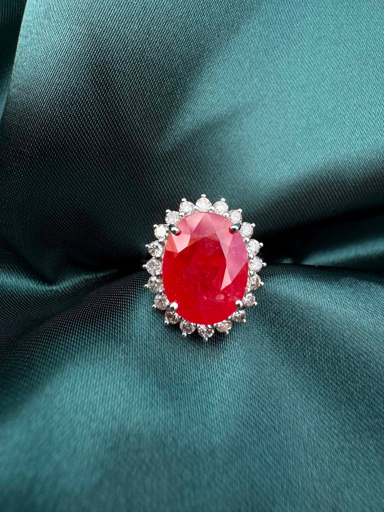 Ruby and diamond halo ring in platinum, top-down view showing oval ruby and diamond halo