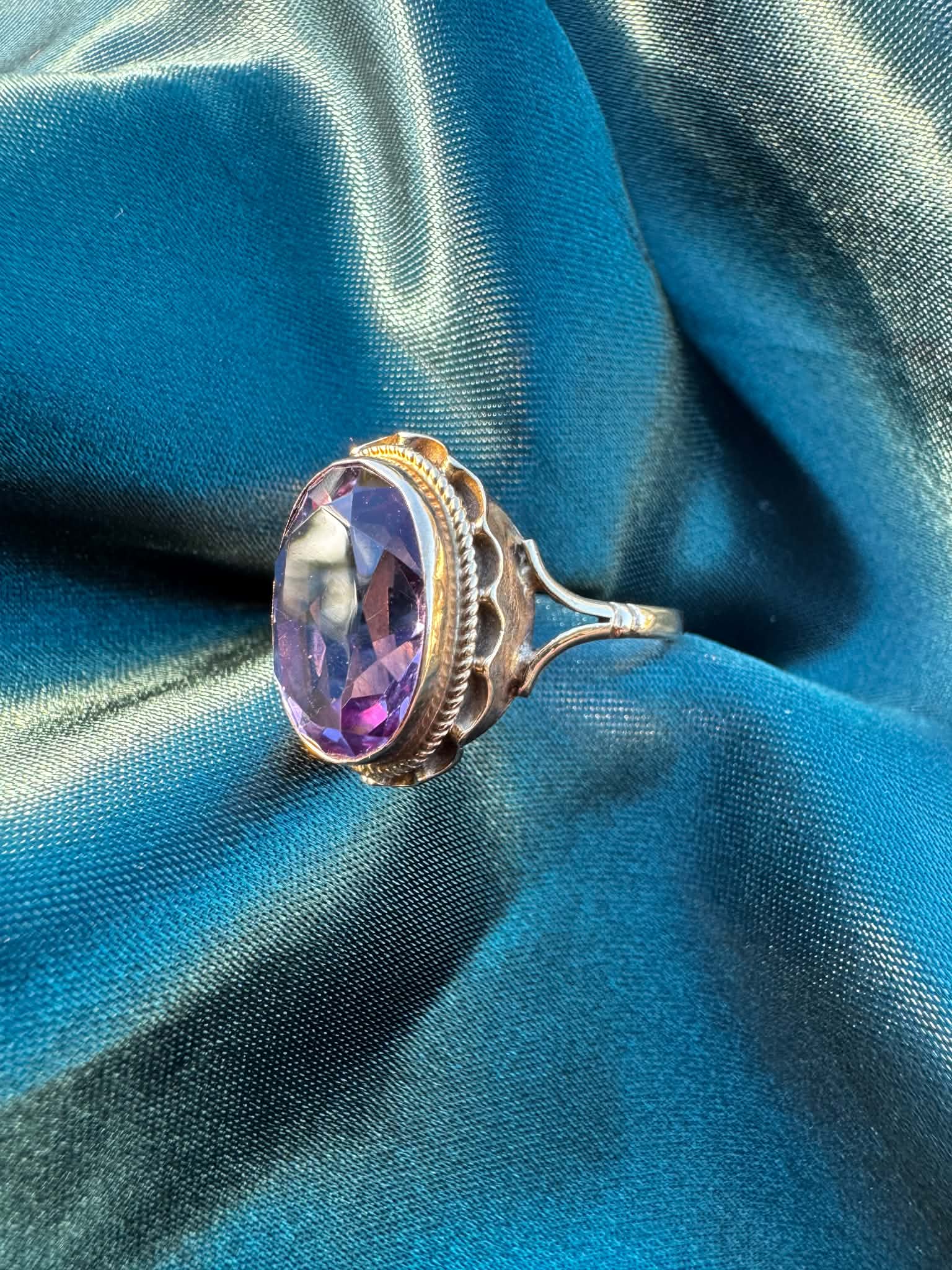 1968 Amethyst Solitaire Ring in 9ct Gold — angled front view of oval amethyst in decorative 9ct gold setting