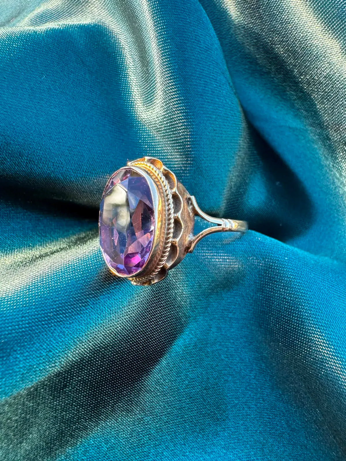 1968 Amethyst Solitaire Ring in 9ct Gold — angled front view of oval amethyst in decorative 9ct gold setting
