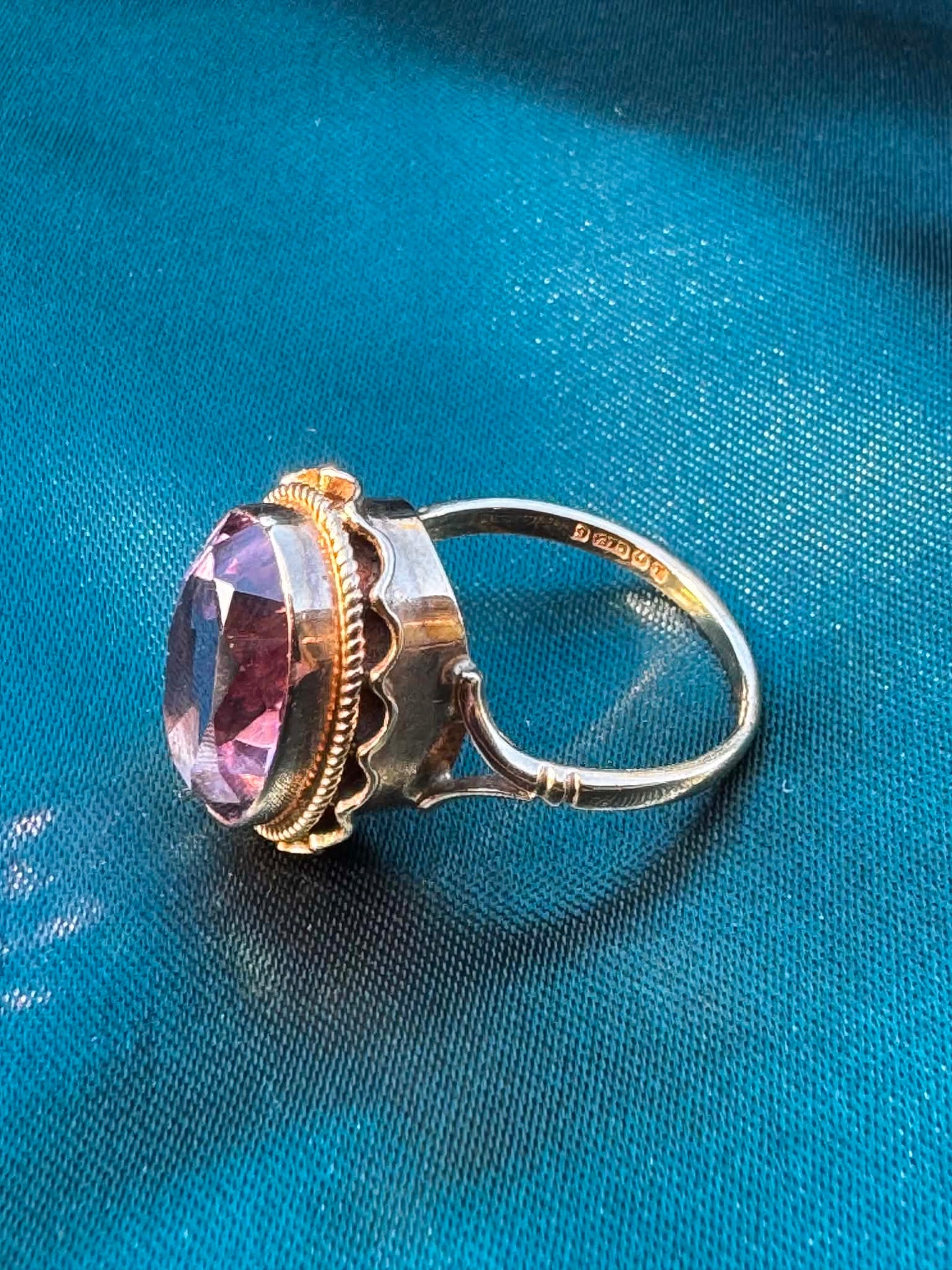 1968 Amethyst Solitaire Ring in 9ct Gold — angled side view of oval amethyst in decorative 9ct gold setting