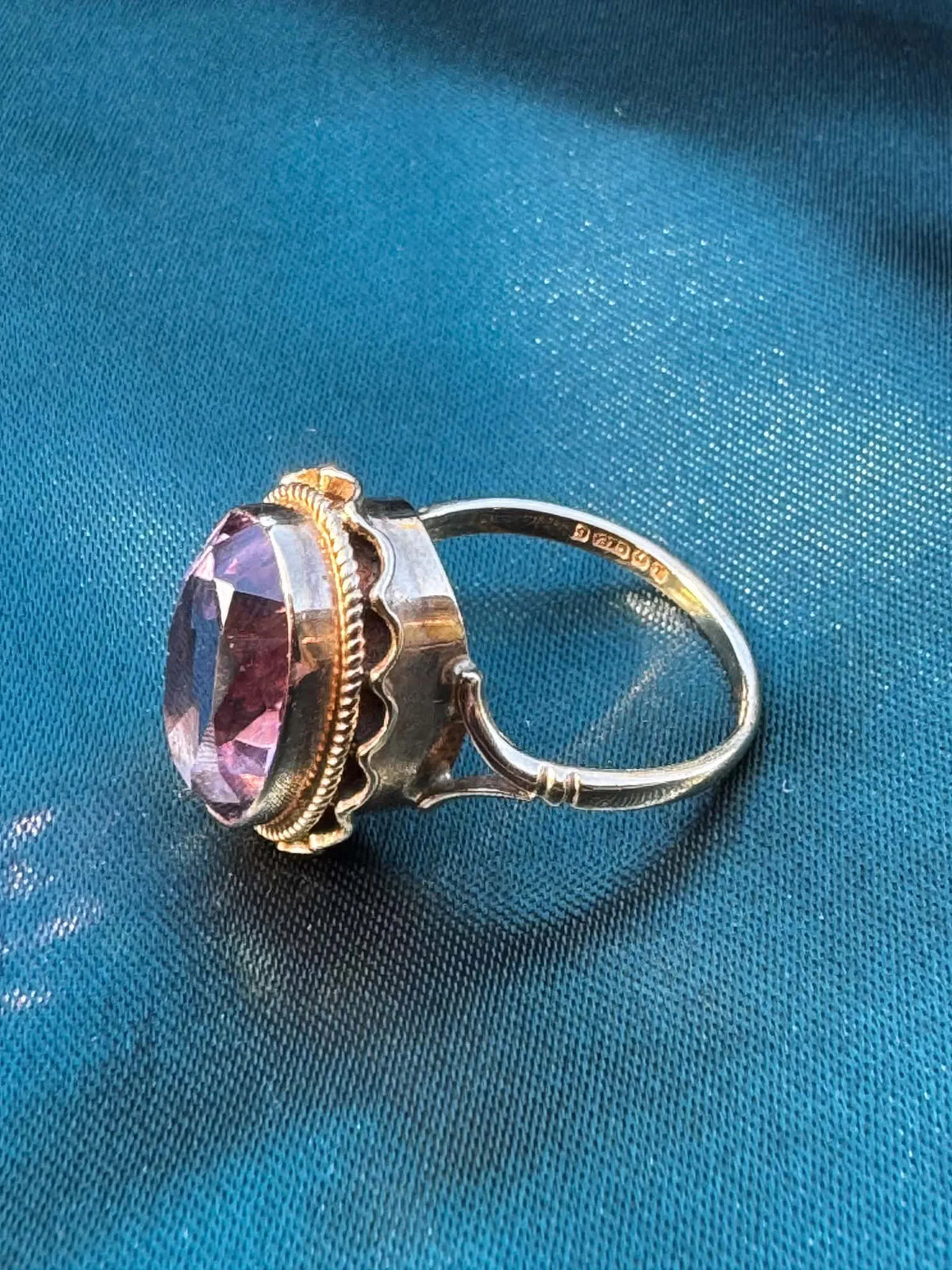 1968 Amethyst Solitaire Ring in 9ct Gold — angled front view of oval amethyst in decorative 9ct gold setting