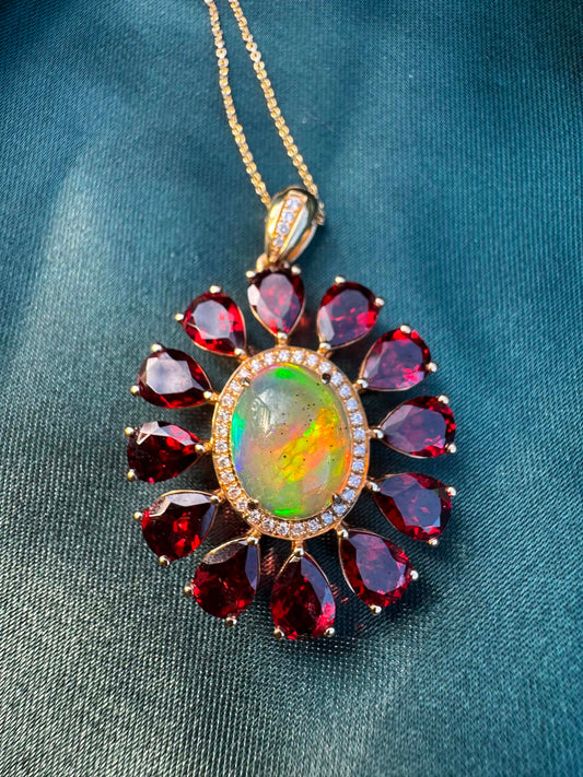 Opal, Garnet & Diamond Pendant in 14ct Gold with oval opal surrounded by garnets and diamond accents