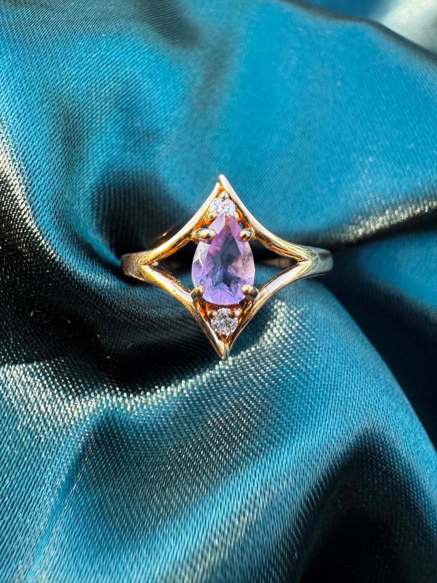 Amethyst and diamond star ring in 9ct gold, top view showing pear-cut amethyst in star setting