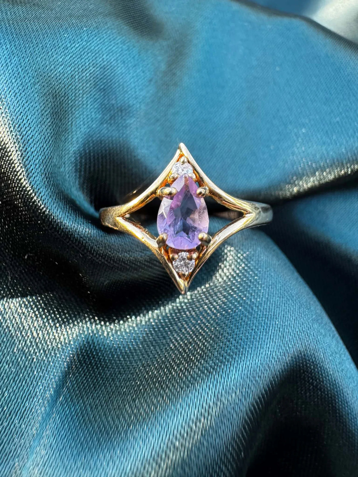 Amethyst and diamond star ring in 9ct gold, top view showing pear-cut amethyst in star setting