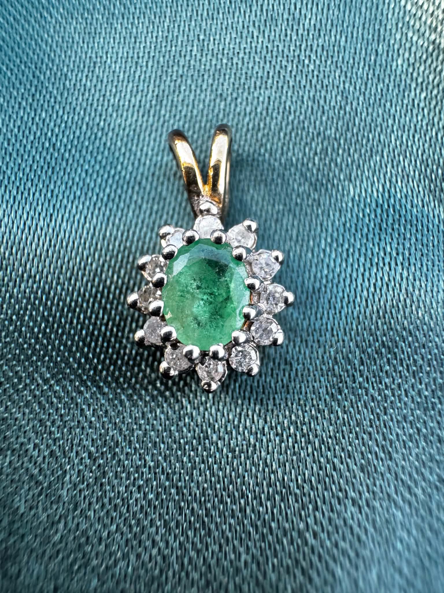 Emerald and diamond halo pendant in two-tone 9ct gold, oval-cut emerald surrounded by diamond halo
