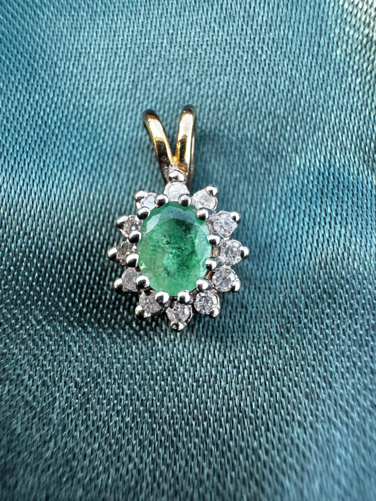 Emerald and diamond halo pendant in two-tone 9ct gold, oval-cut emerald surrounded by diamond halo