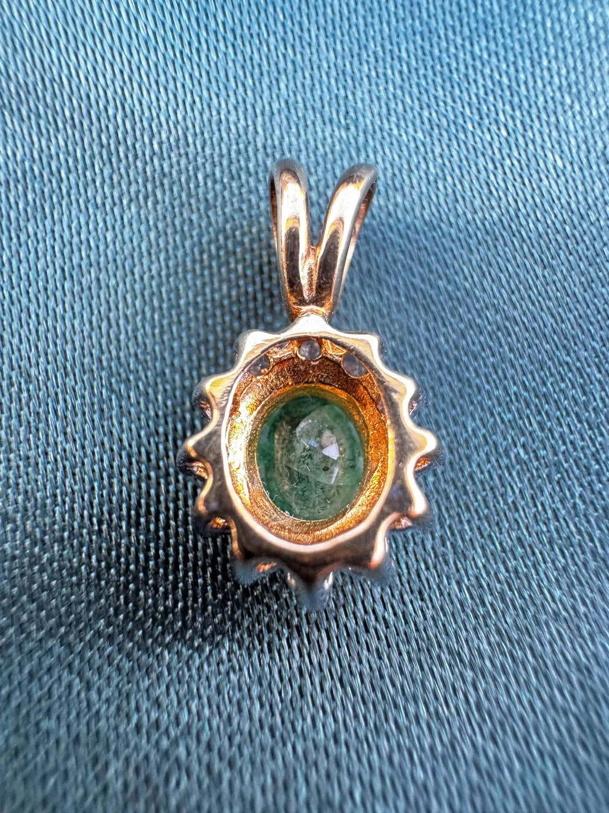 Emerald and diamond halo pendant in two-tone 9ct gold, reverse side showing bail and pendant back