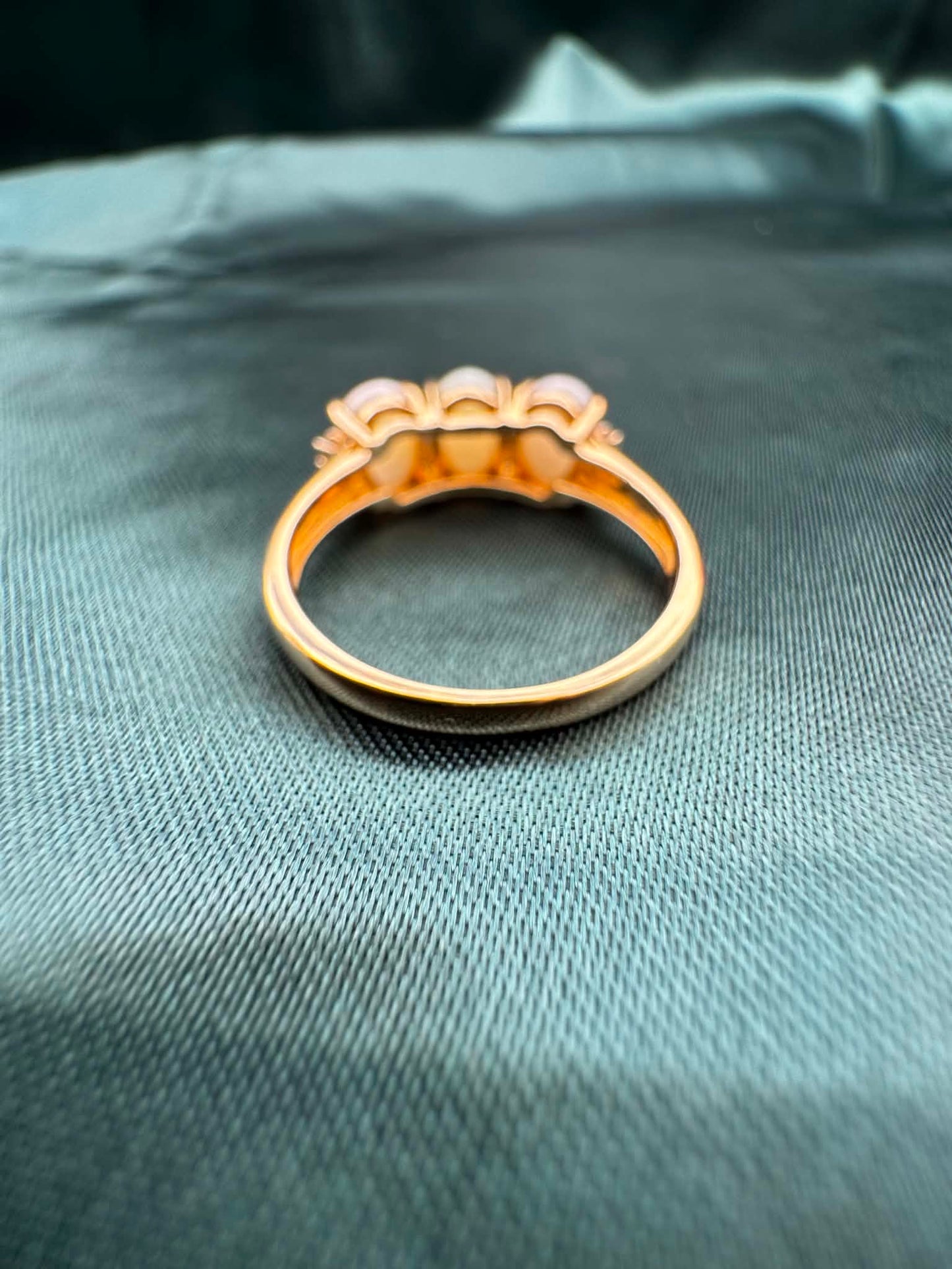 Three-stone white opal ring in 9ct yellow gold, reverse view showing gold band interior
