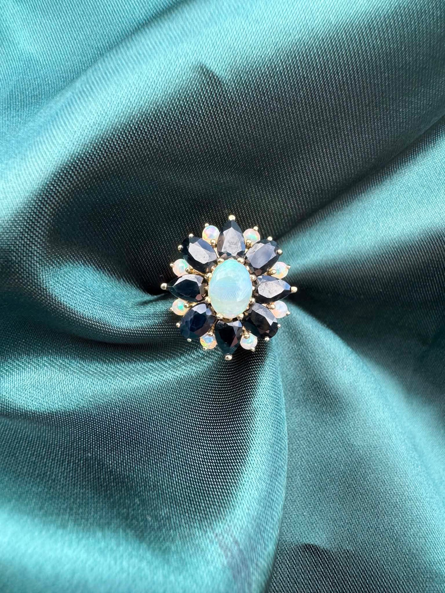 Opal and sapphire cluster ring in 9ct gold, natural opal centre with sapphire and diamond accents