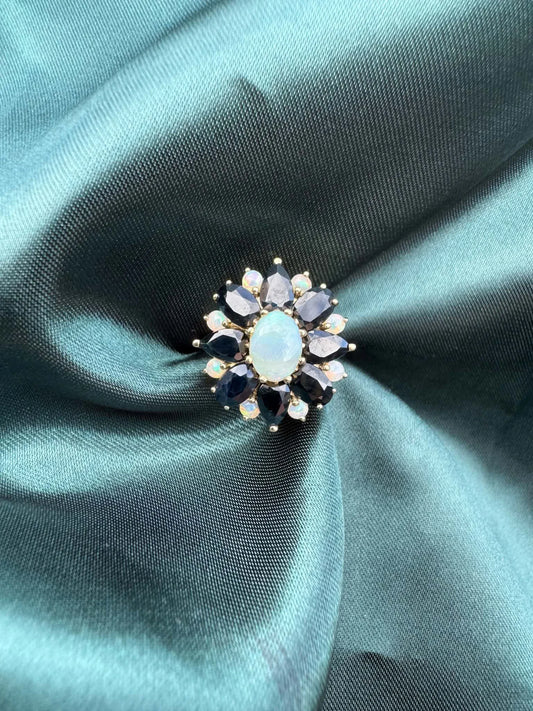 Opal and sapphire cluster ring in 9ct gold, natural opal centre with sapphire and diamond accents