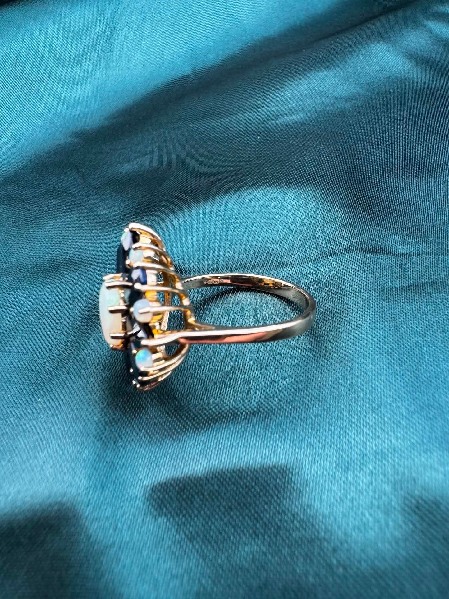 Opal and sapphire cluster ring in 9ct gold, side angle.