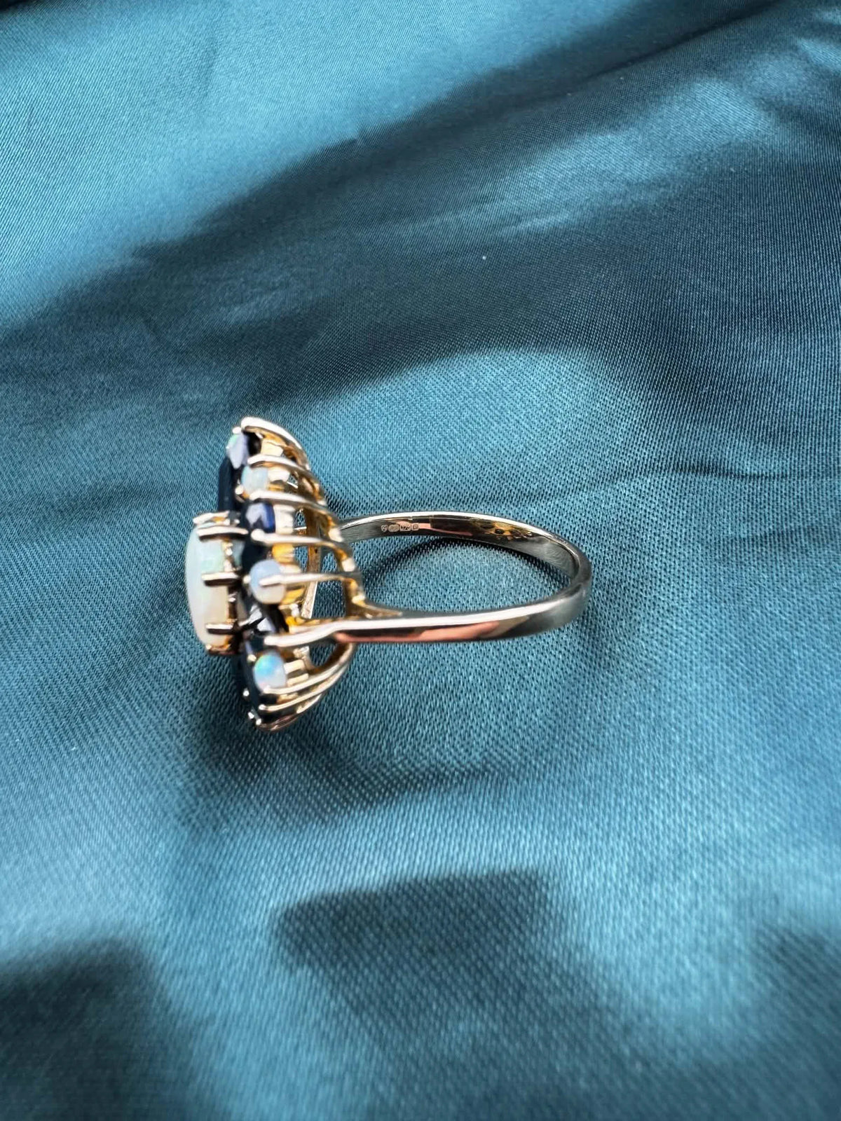 Opal and sapphire cluster ring in 9ct gold, side angle.