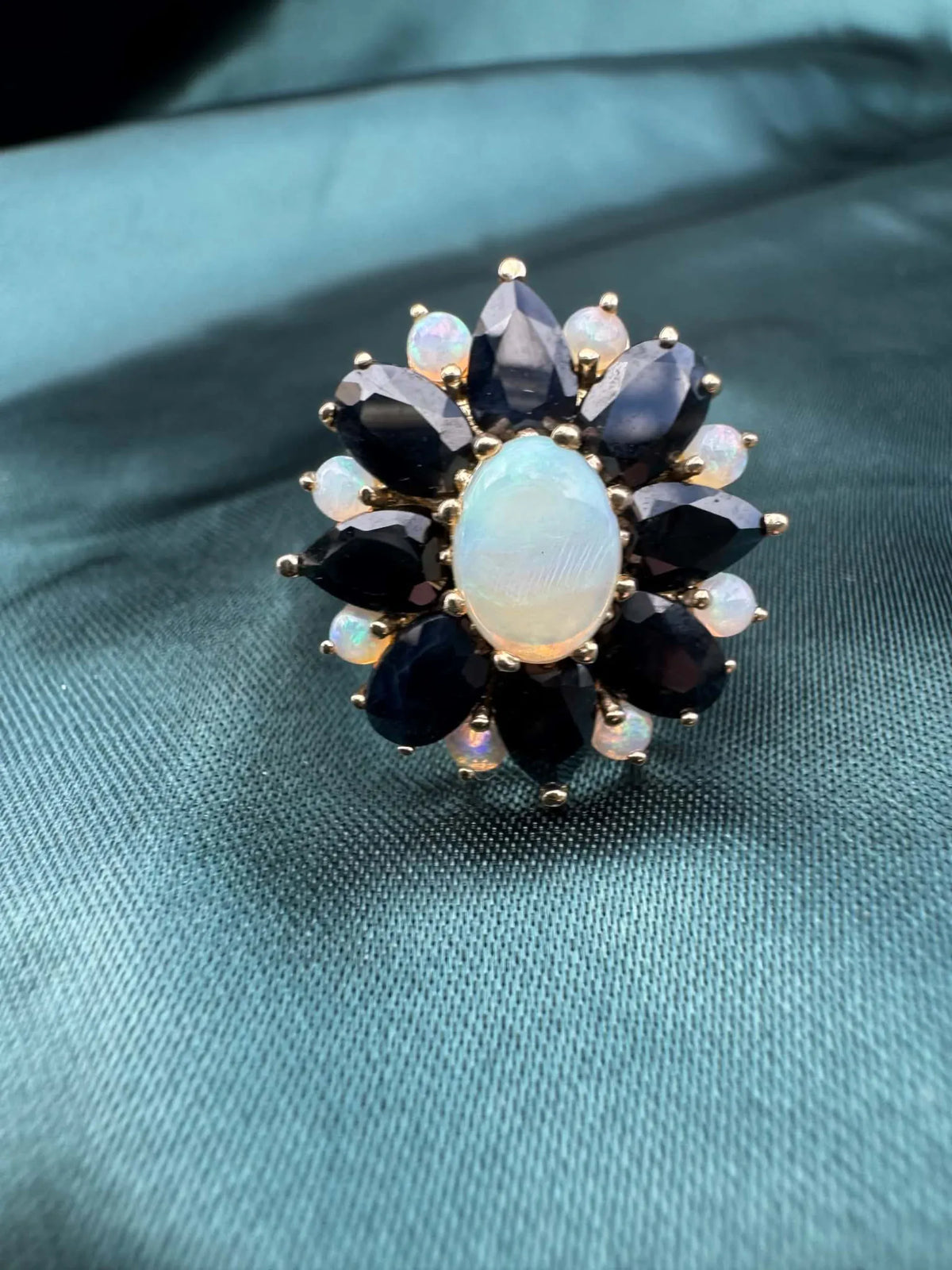 Opal and sapphire cluster ring in 9ct gold, close-up of opal and sapphire cluster setting