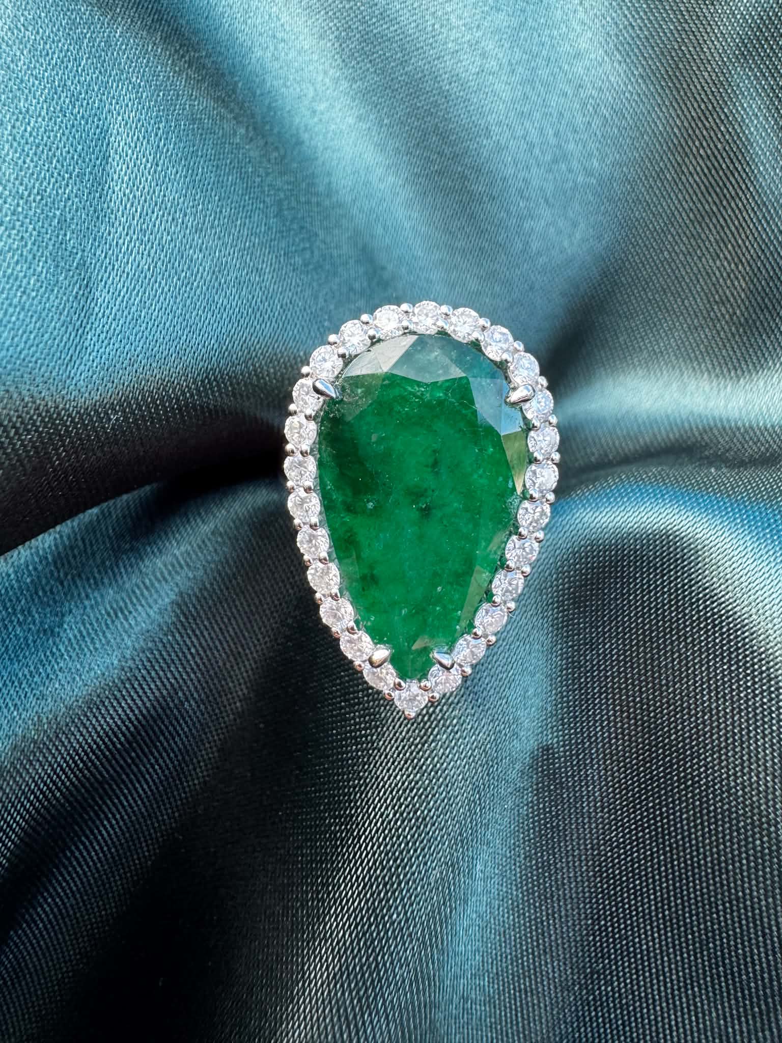 8.28ct pear emerald and diamond halo ring in platinum
