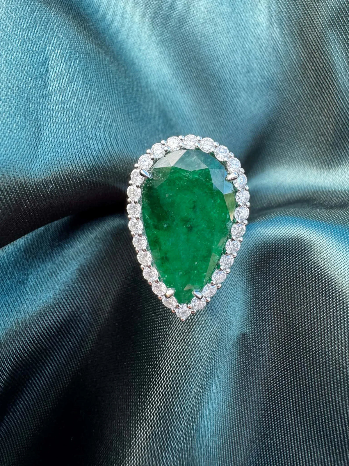8.28ct pear emerald and diamond halo ring in platinum