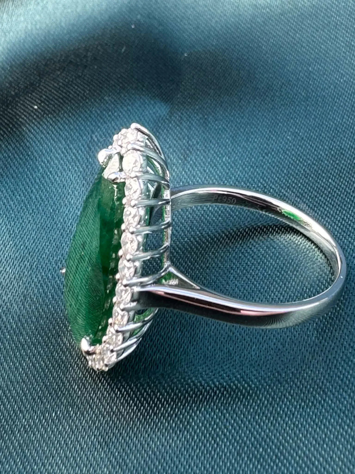 8.28ct pear emerald and diamond halo ring in platinum, side profile showing diamond halo setting and platinum band
