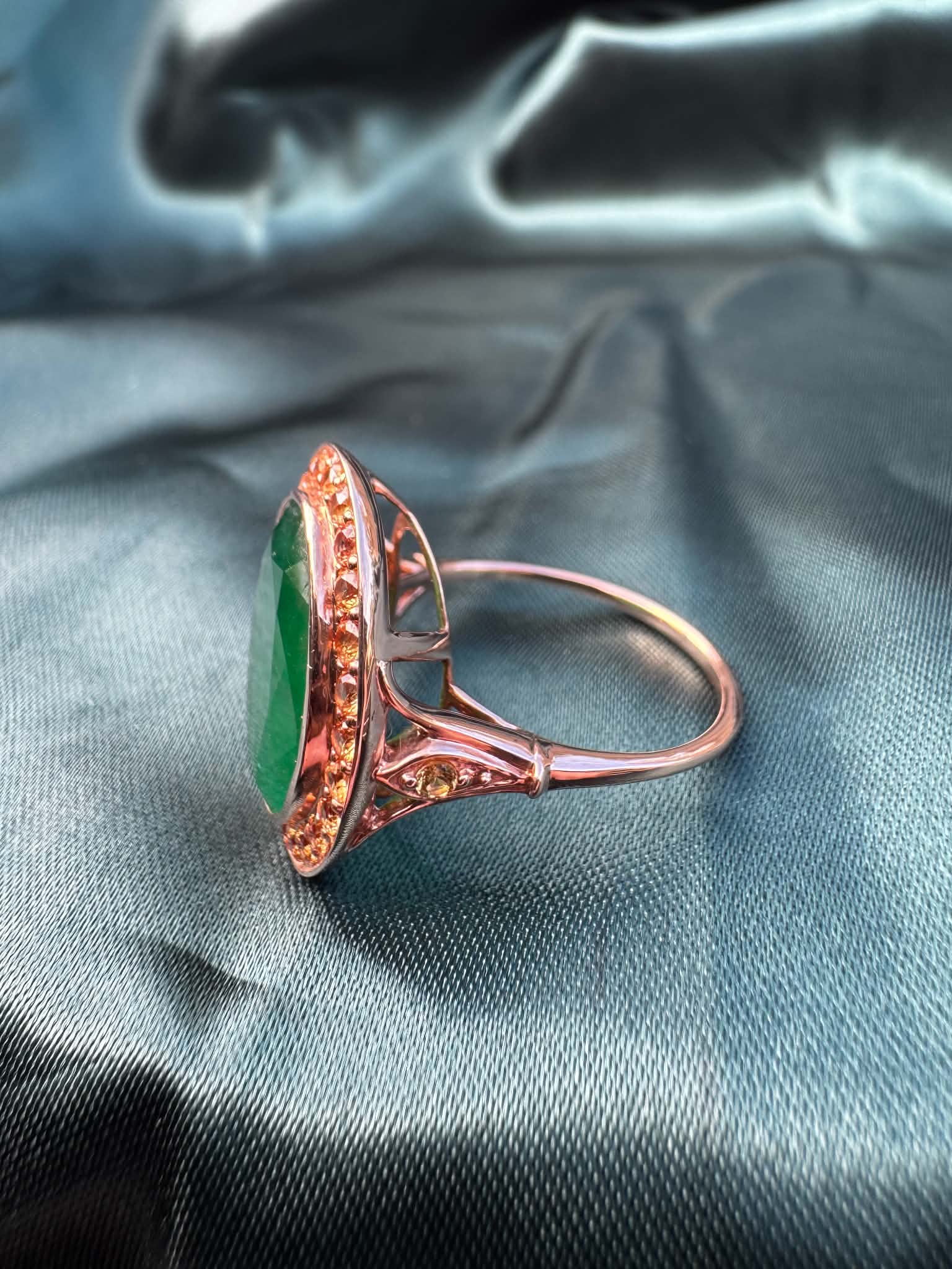 Emerald and orange sapphire cocktail ring in 14ct rose gold, side profile showing band