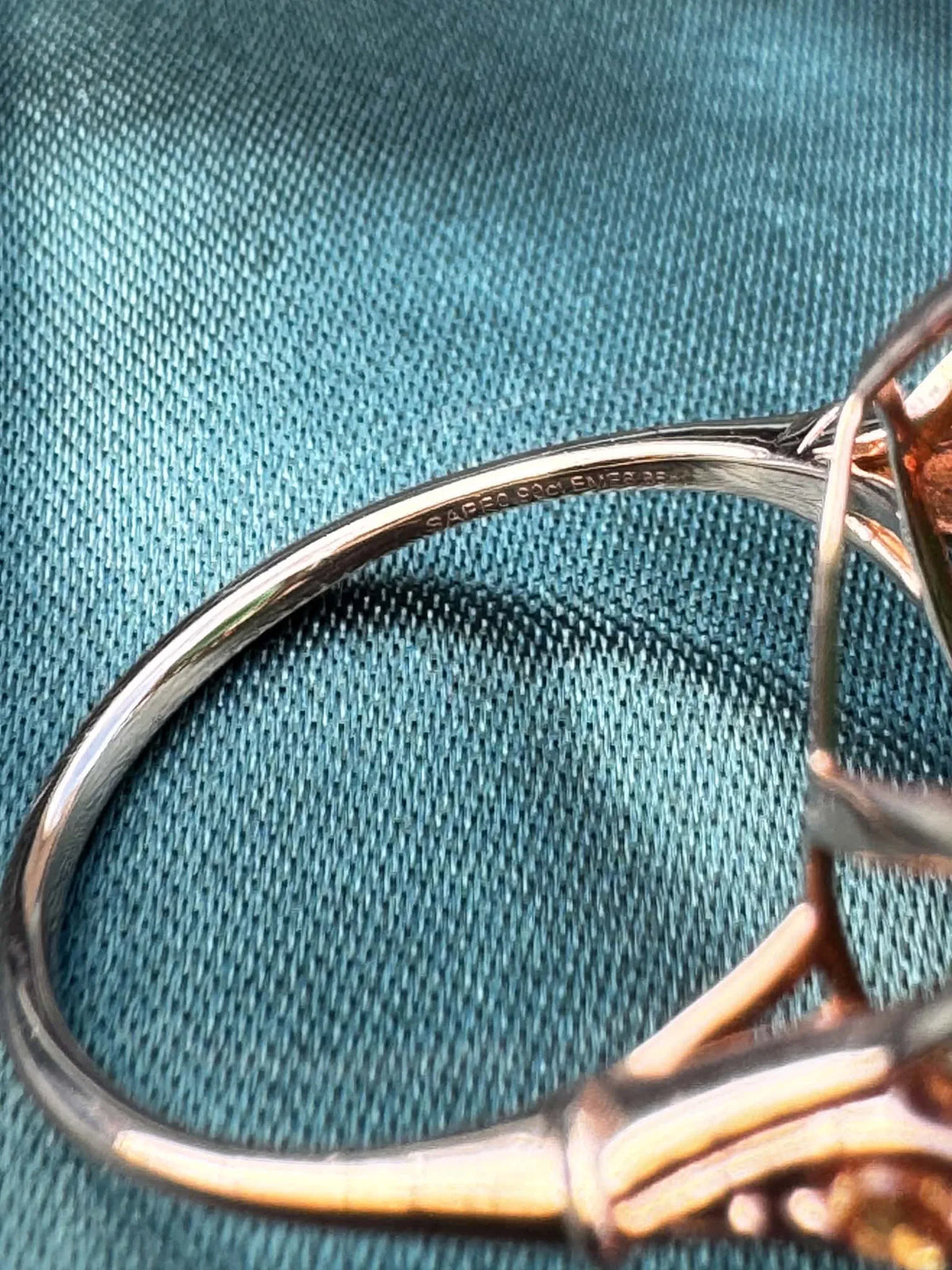 Emerald and orange sapphire cocktail ring in 14ct rose gold, side profile showing band and bezel setting