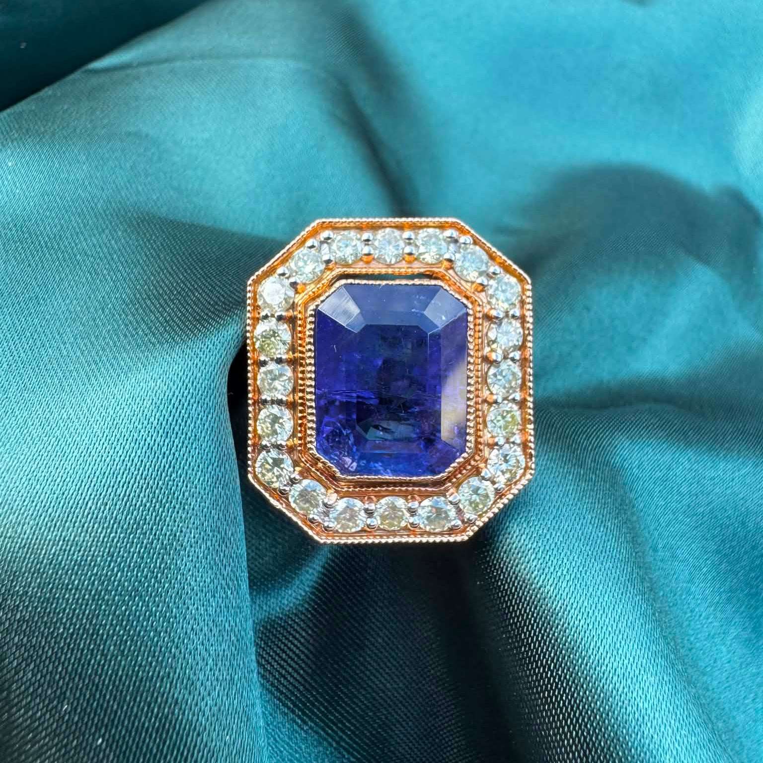 Tanzanite and diamond halo ring in 18ct rose gold, top view showing emerald-cut tanzanite in octagonal diamond halo