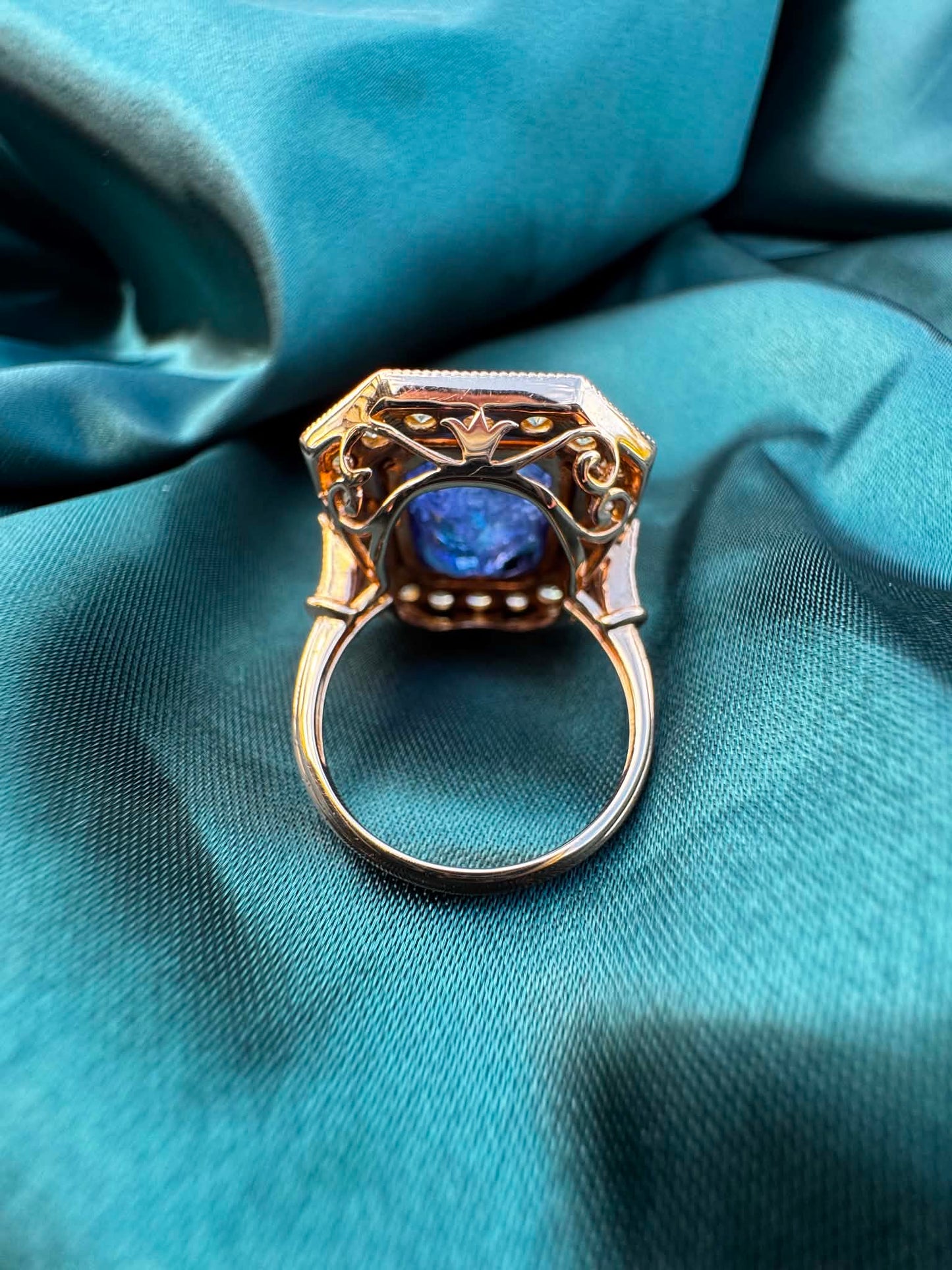 Tanzanite and diamond halo ring in 18ct rose gold, underside view showing ring band