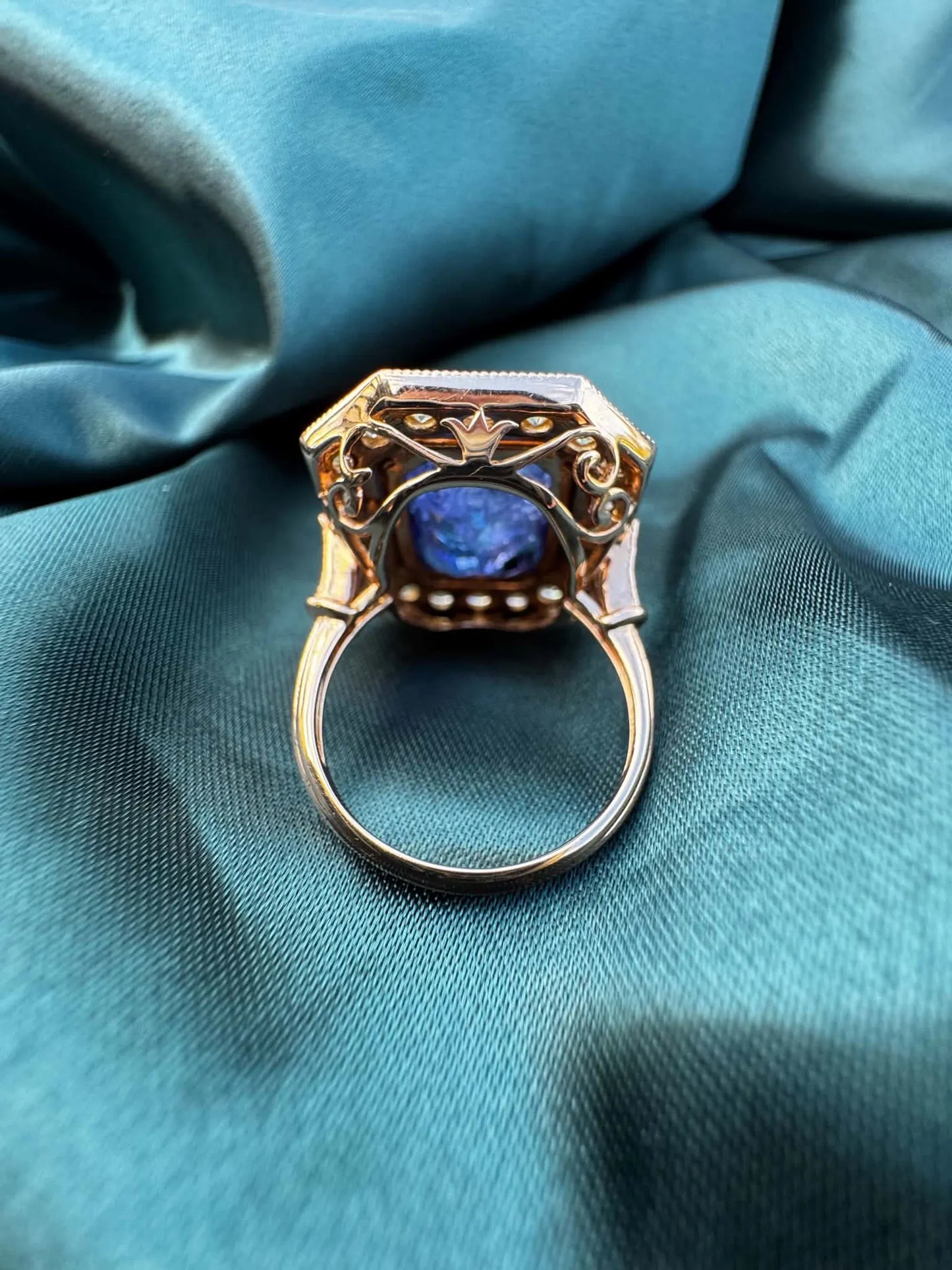 Tanzanite and diamond halo ring in 18ct rose gold, underside view showing ring band