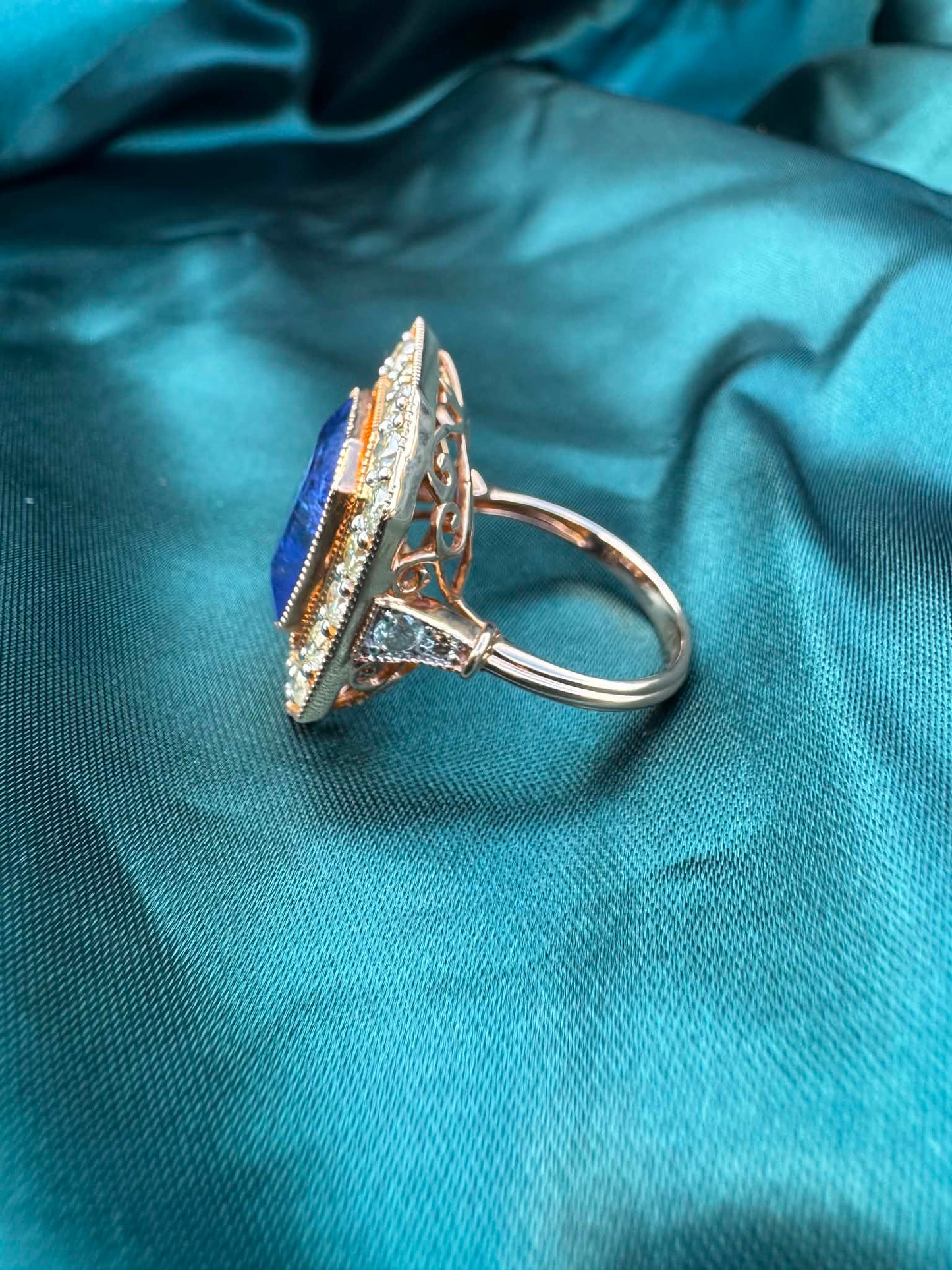 Tanzanite and diamond halo ring in 18ct rose gold, side profile showing band and polished finish