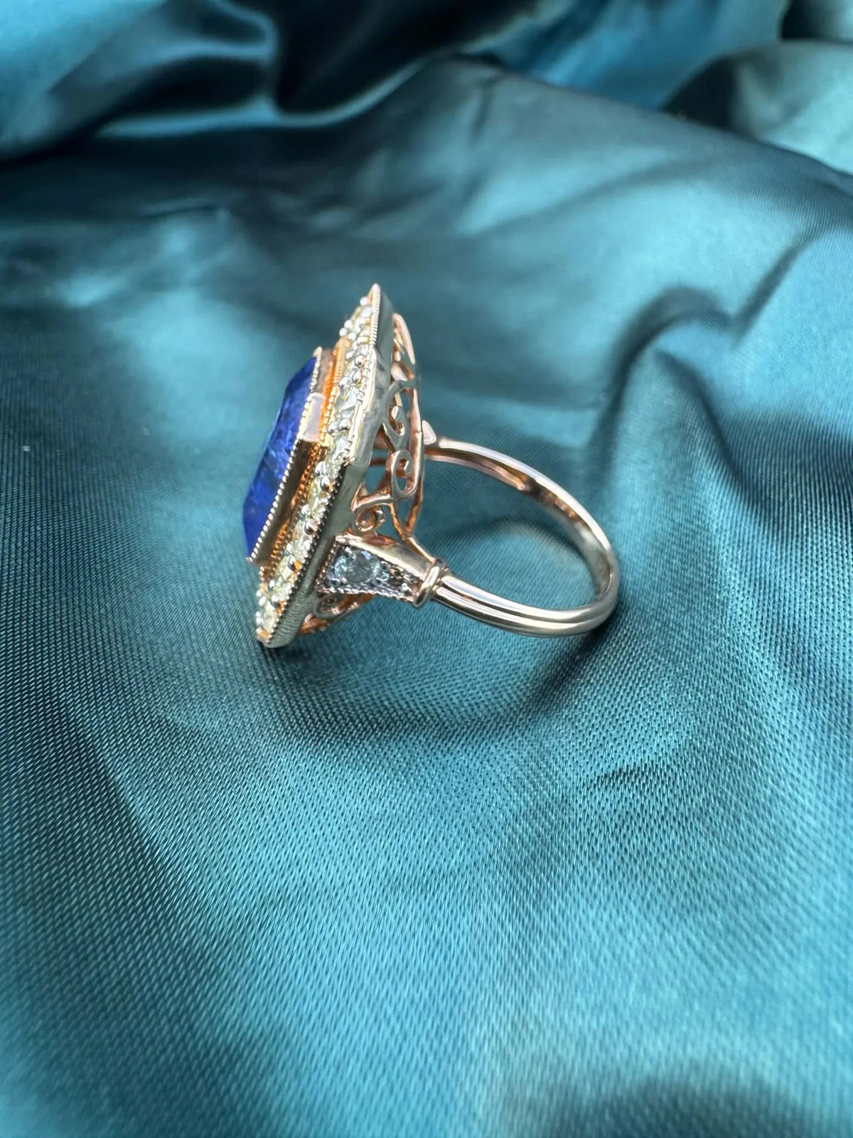 Tanzanite and diamond halo ring in 18ct rose gold, side profile showing band and polished finish