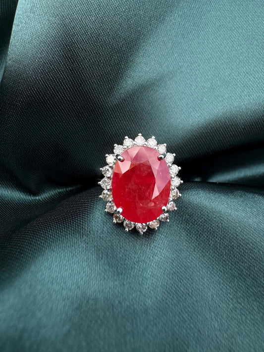 Ruby and diamond halo ring in platinum, top-down view showing oval ruby and diamond halo
