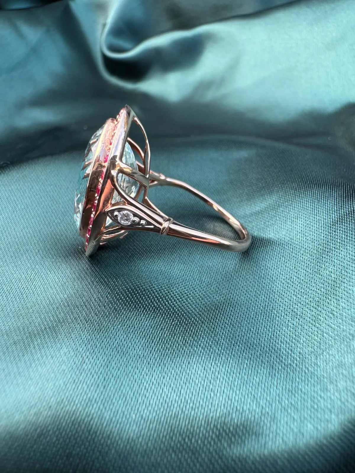 Aquamarine and gemstone halo ring in 14ct rose gold, side profile showing band and setting