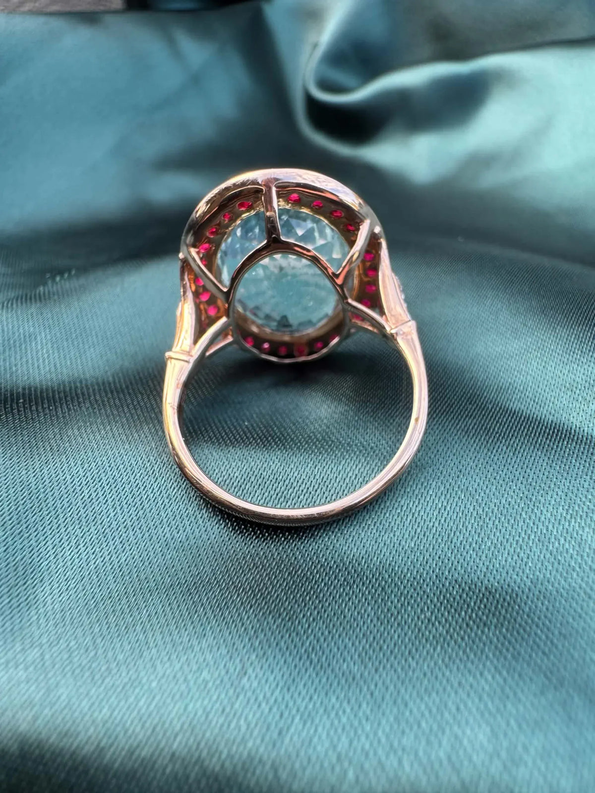 Aquamarine and gemstone halo ring in 14ct rose gold, reverse view showing open-back construction