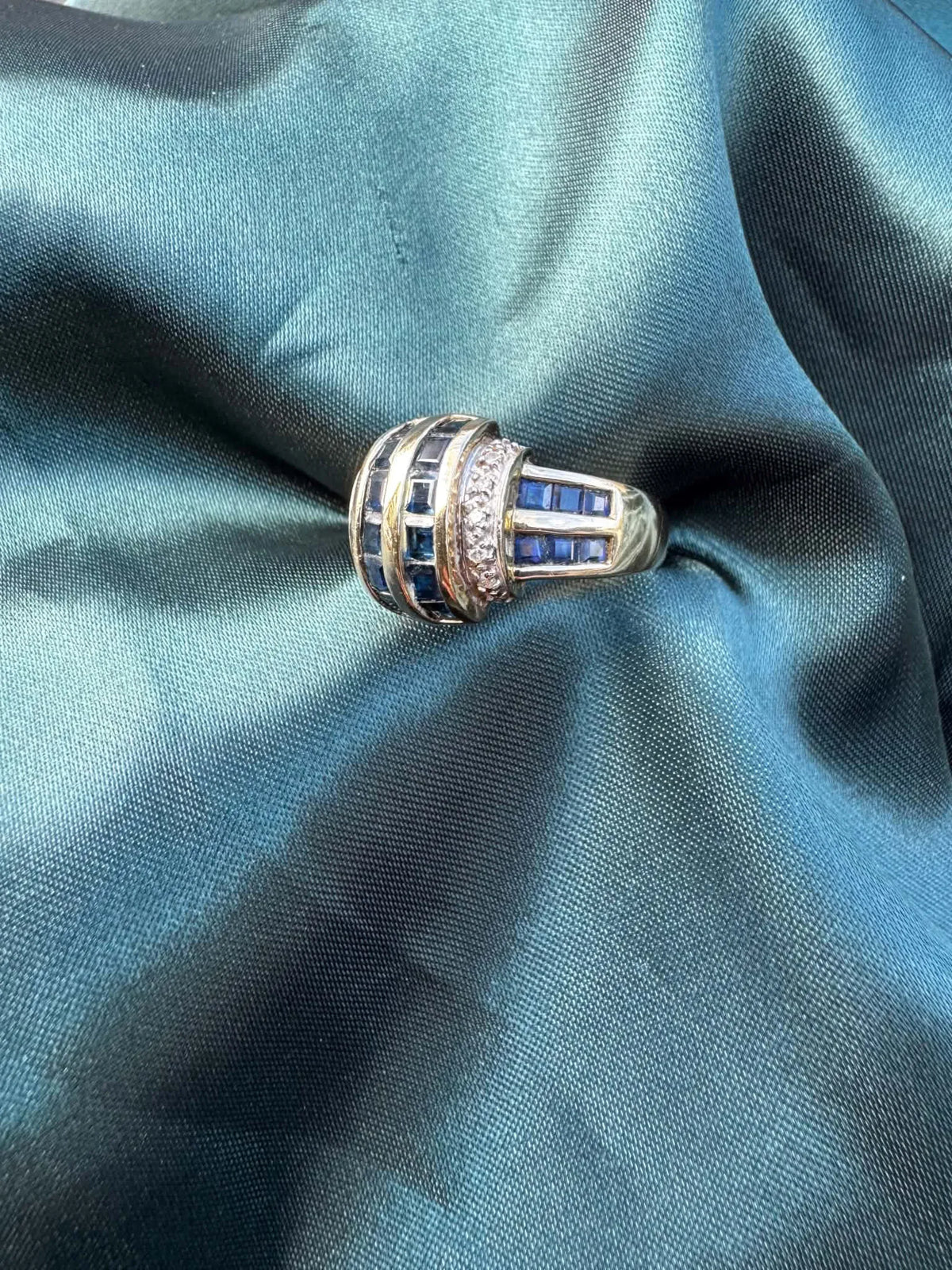 Sapphire and diamond dress ring in 9ct yellow gold, angled view showing sapphires and diamonds