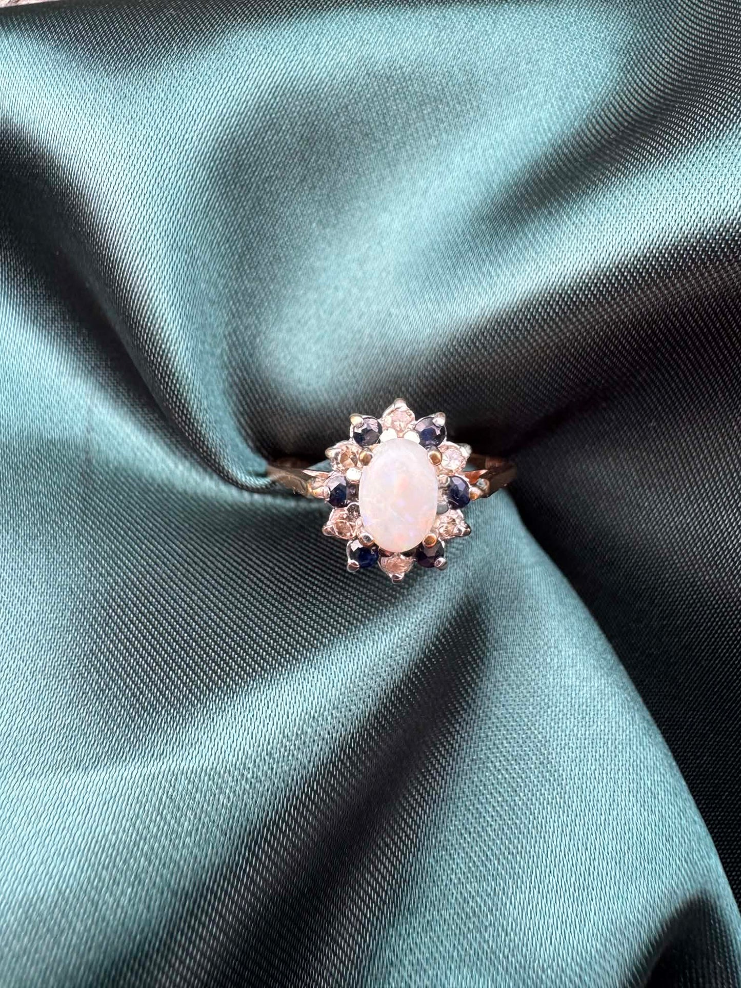 Opal, diamond and gem cluster ring in 9ct yellow gold, front view showing opal centre stone