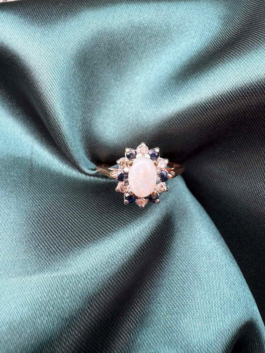 Opal, diamond and gem cluster ring in 9ct yellow gold, front view showing opal centre stone