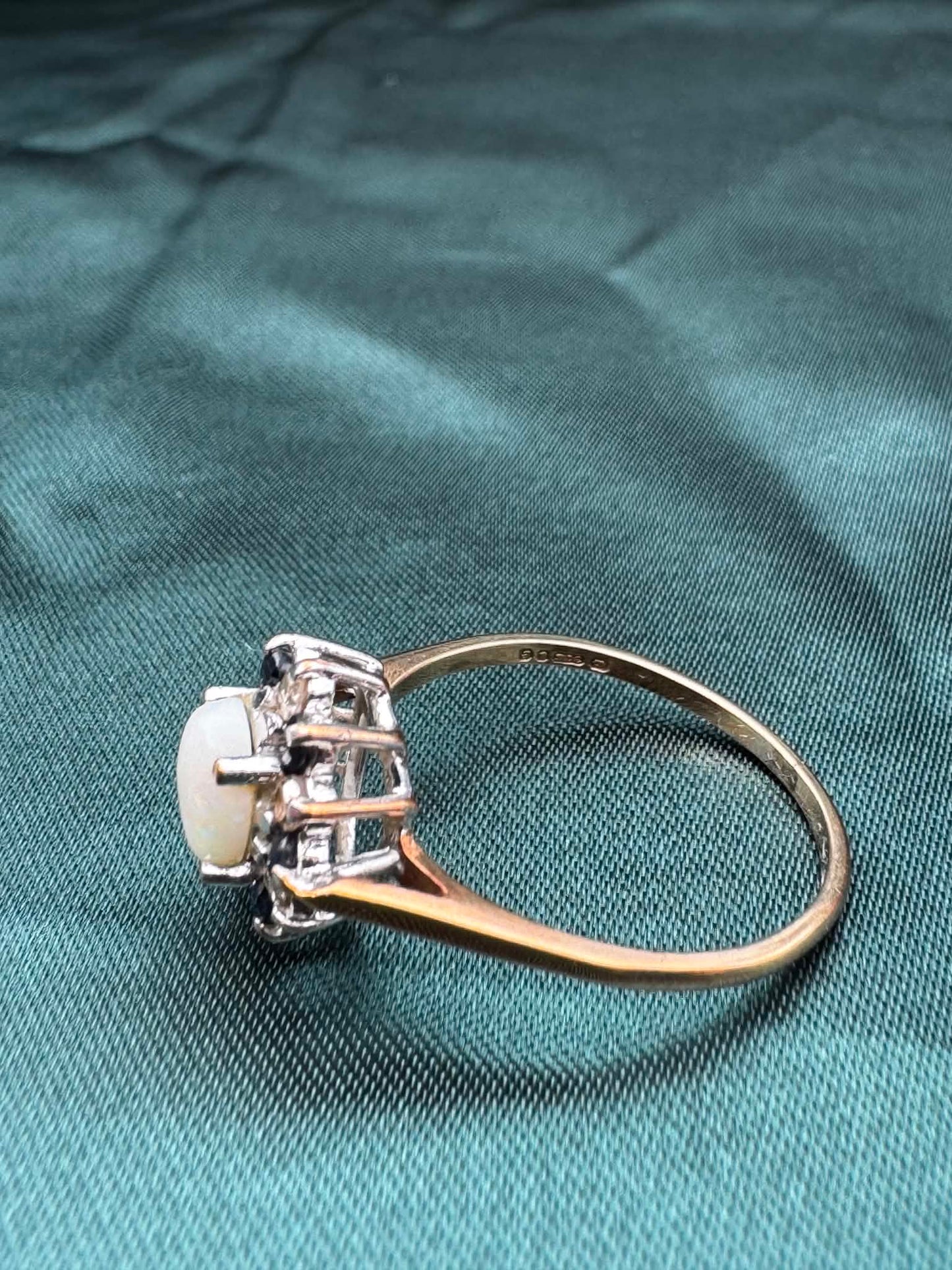 Opal, diamond and gem cluster ring in 9ct yellow gold, side angled view showing cluster setting