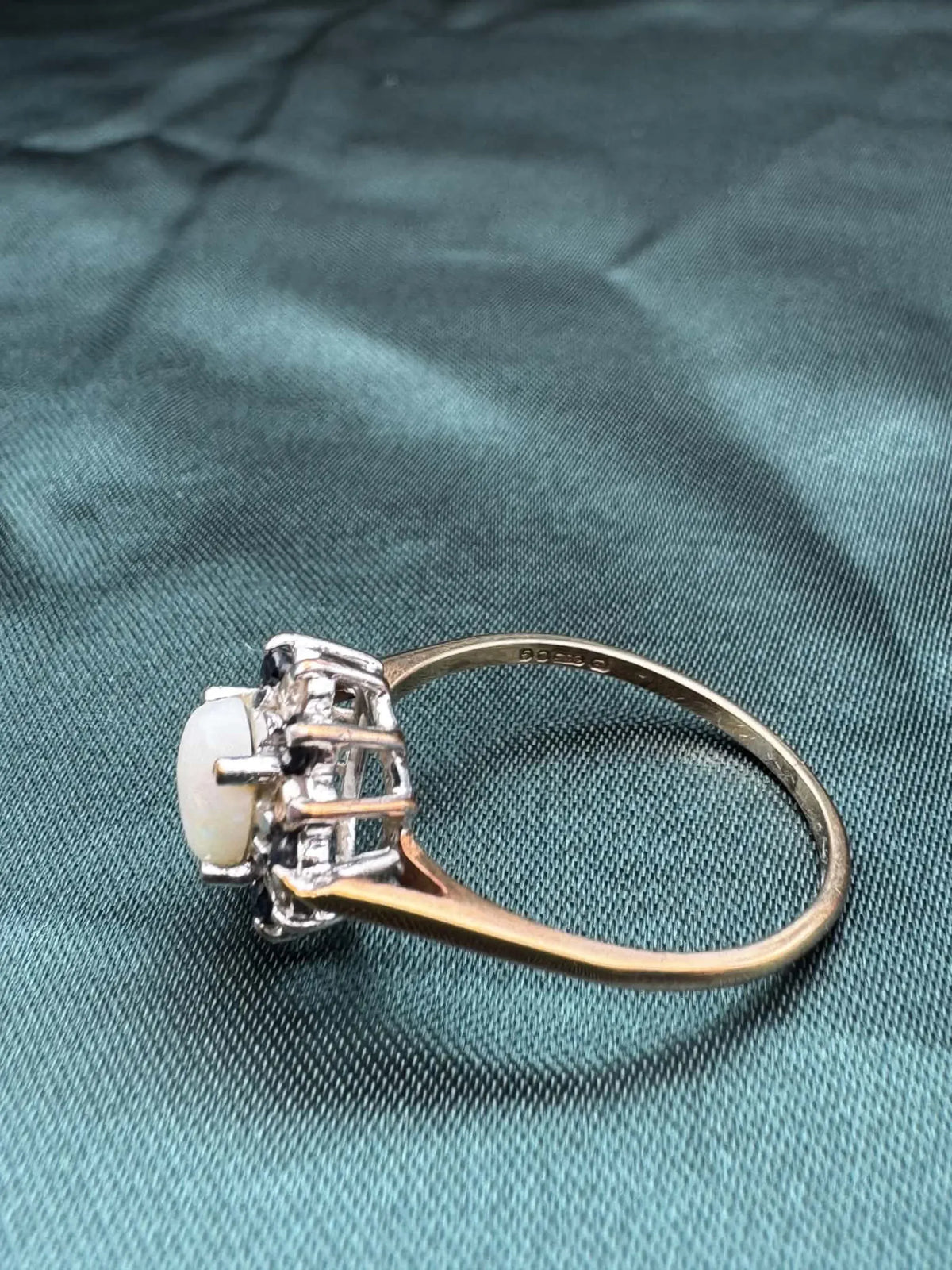 Opal, diamond and gem cluster ring in 9ct yellow gold, side angled view showing cluster setting