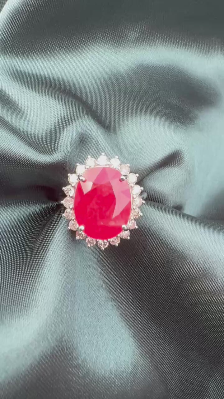 Ruby and diamond halo ring in platinum, front view showing oval ruby and diamond halo