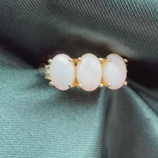 Three-stone white opal ring in 9ct yellow gold