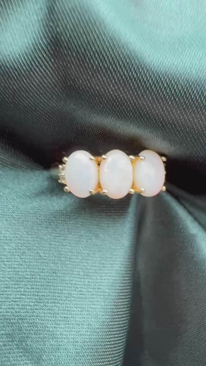 Three-stone white opal ring in 9ct yellow gold