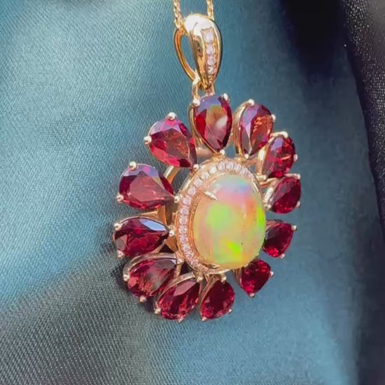 Opal, Garnet & Diamond Pendant in 14ct Gold — angled view showing opal, garnets and diamond accents