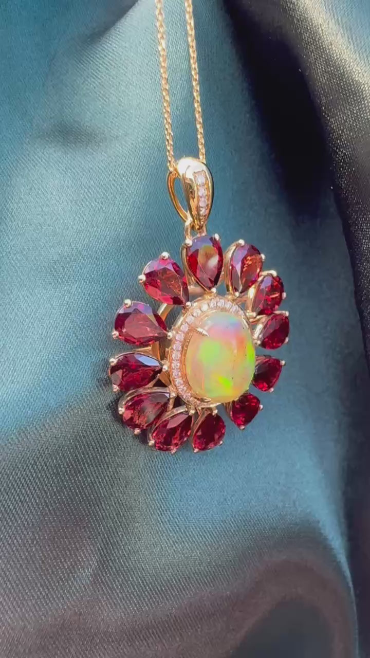 Opal, Garnet & Diamond Pendant in 14ct Gold — angled view showing opal, garnets and diamond accents