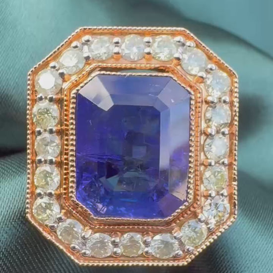 Tanzanite and diamond halo ring in 18ct rose gold, close top view showing emerald-cut tanzanite and octagonal diamond halo