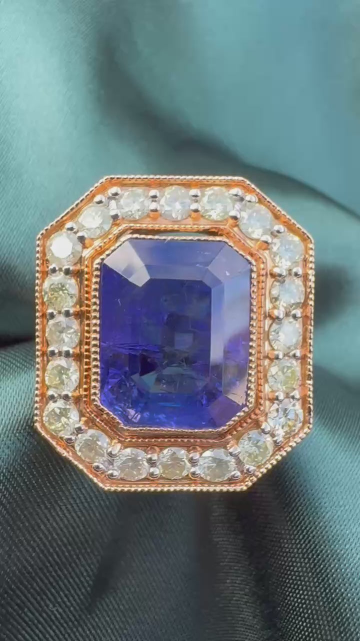 Tanzanite and diamond halo ring in 18ct rose gold, close top view showing emerald-cut tanzanite and octagonal diamond halo