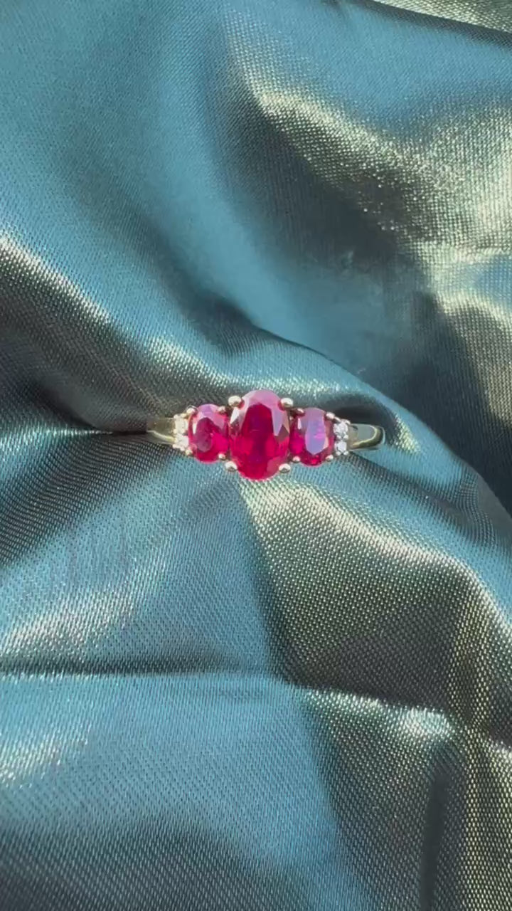 Ruby and diamond trilogy ring in 9ct yellow gold