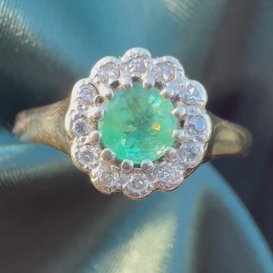 Emerald and diamond halo ring in 9ct yellow gold