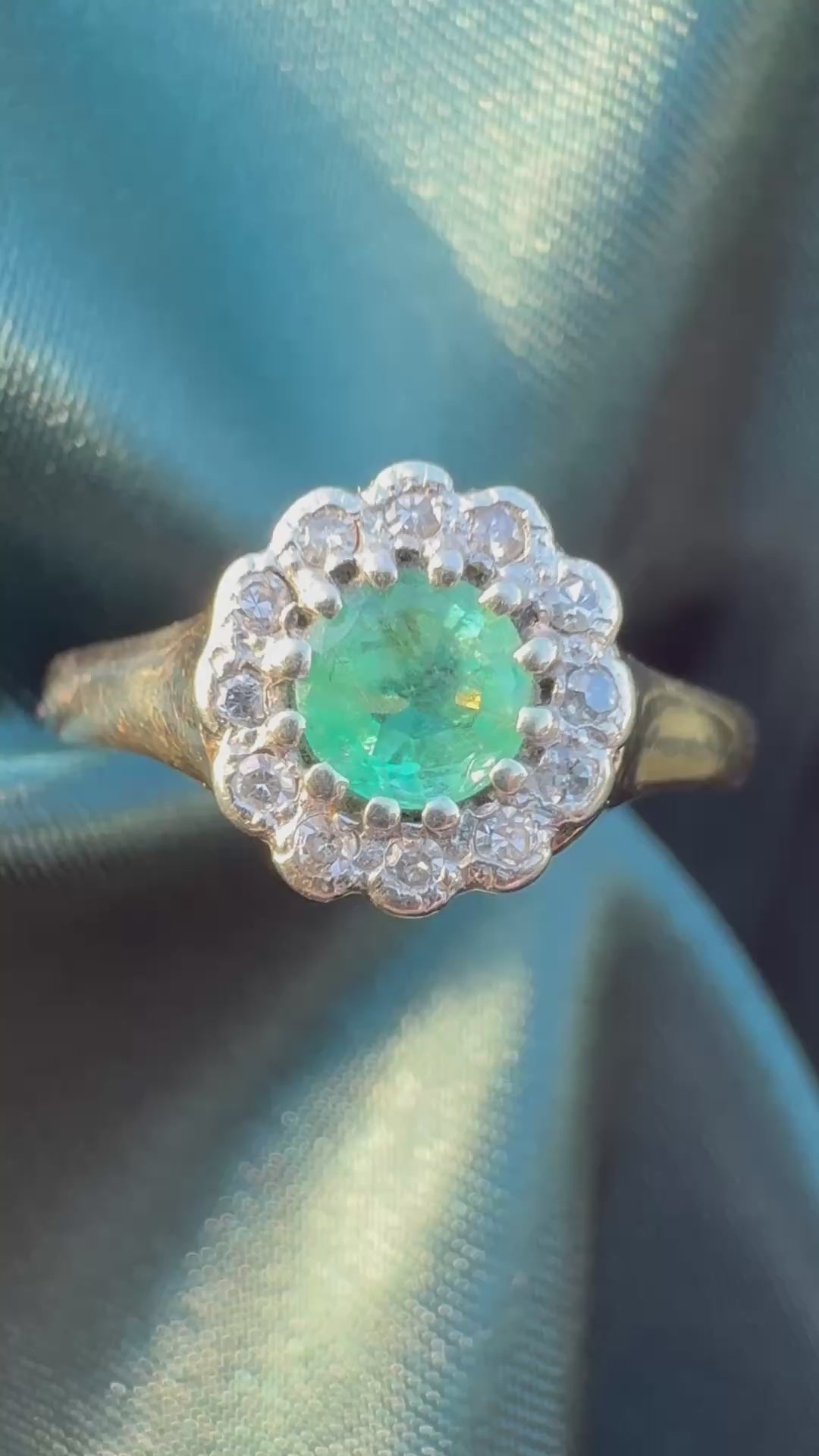 Emerald and diamond halo ring in 9ct yellow gold