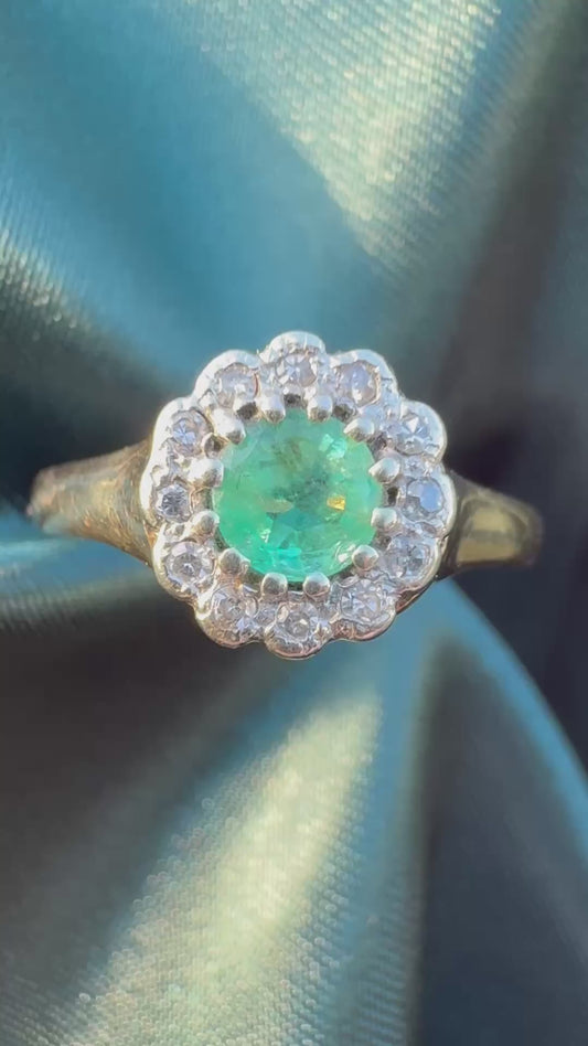 Emerald and diamond halo ring in 9ct yellow gold